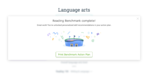 A popup window that says "Reading Benchmark complete! Great work! You've unlocked personalized skill recommendations in your action plan." There is an illustration of a blue arena with flags waving and confetti falling down around it. Underneath is a button that says "Print Benchmark Action Plan."