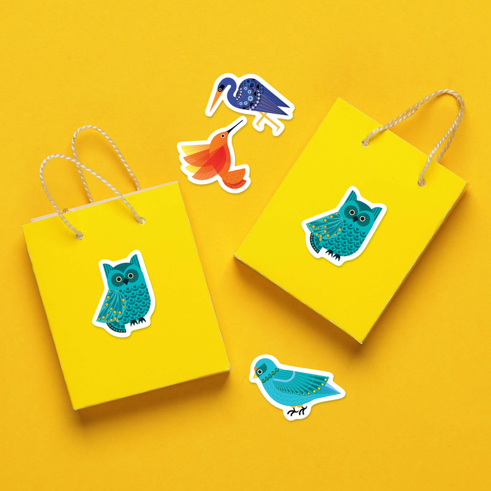 Stickers of birds, including owls, hummingbirds, and cranes, are stuck to yellow gift bags and a yellow background.